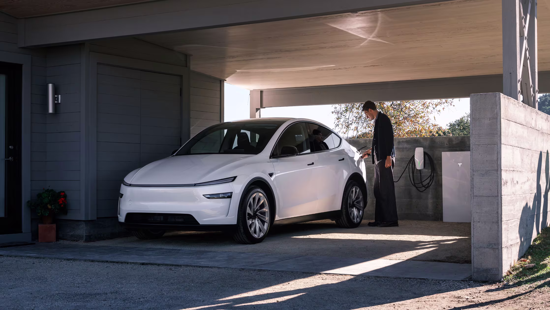 Garajda ev şarj cihazına takılı Tesla